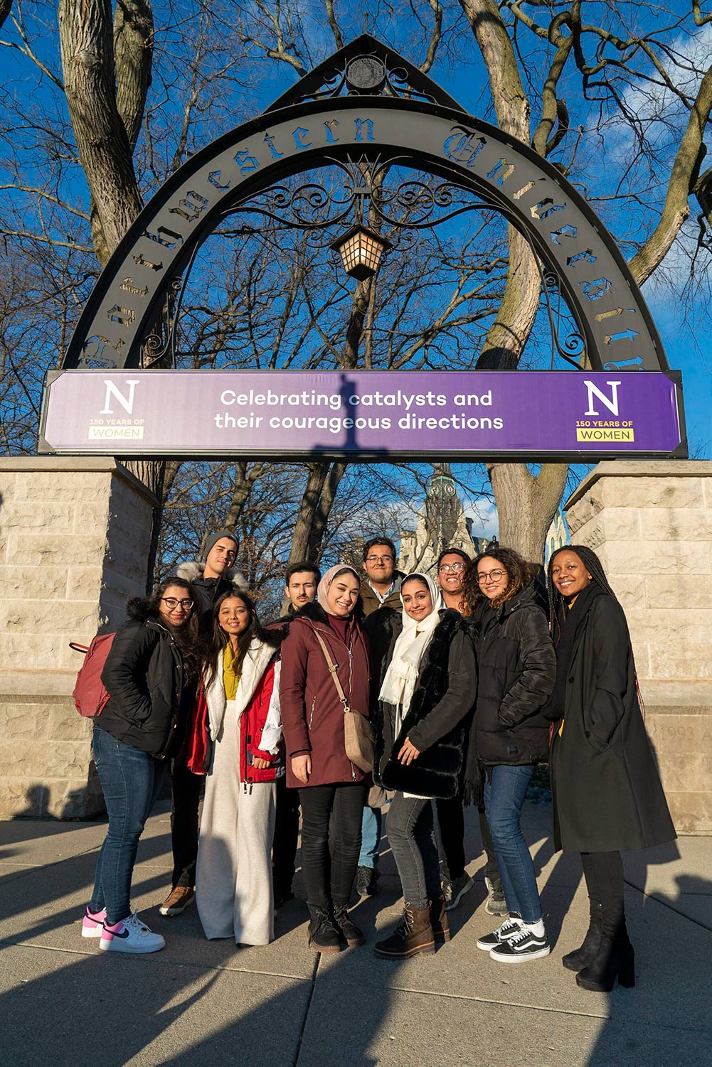NU-Q ambassadors stand by Northwestern's Weber Arch.