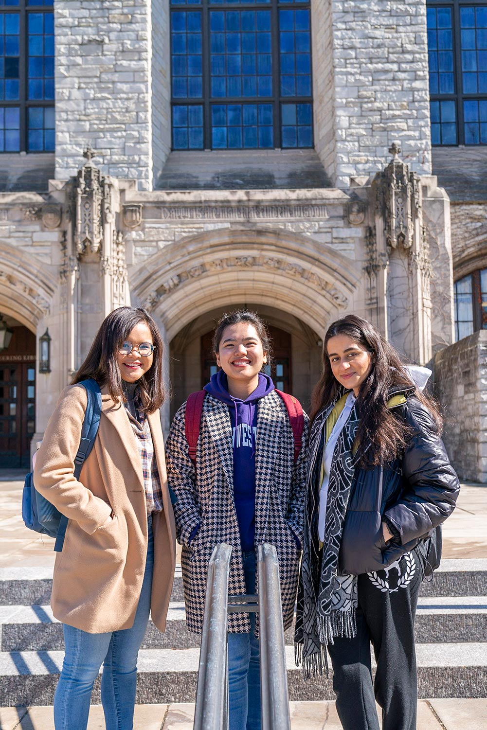 NU-Q students (left to right) Nur Munawarah, Marielle Cortel, and Belkees Al Jaafari, stand by the Northwestern University Library while on the exchange program. 