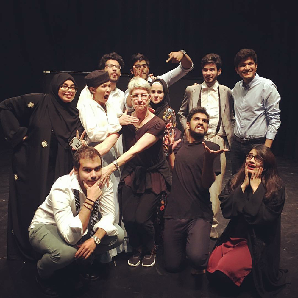 Professor Ann Woodworth (center) with a group of theater students at NU-Q in 2017.
