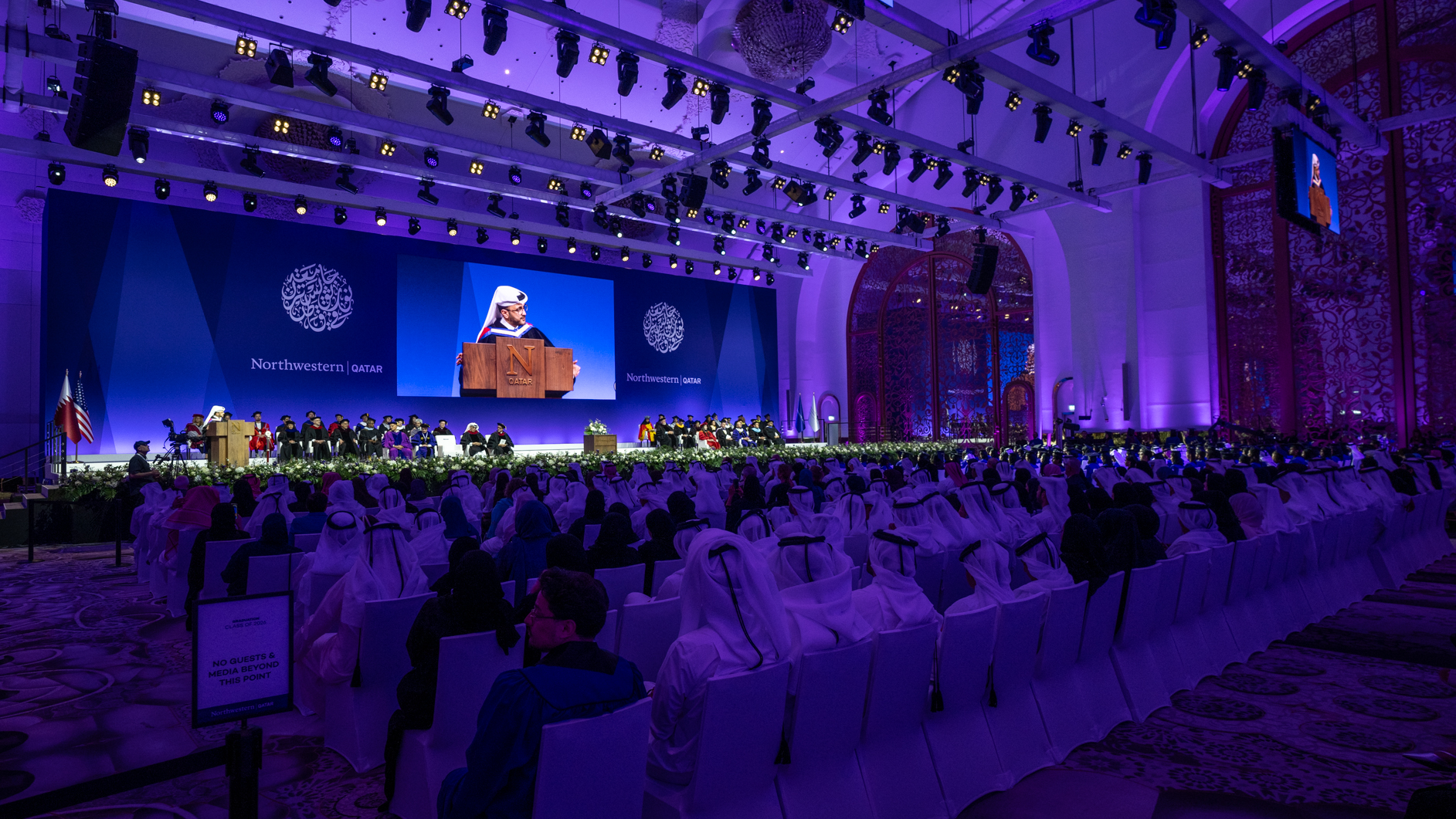 Dr. Majed Mohammed Al-Ansari delivers the graduation address, emphasizing the responsibility of communication and the impact of words in shaping public understanding.